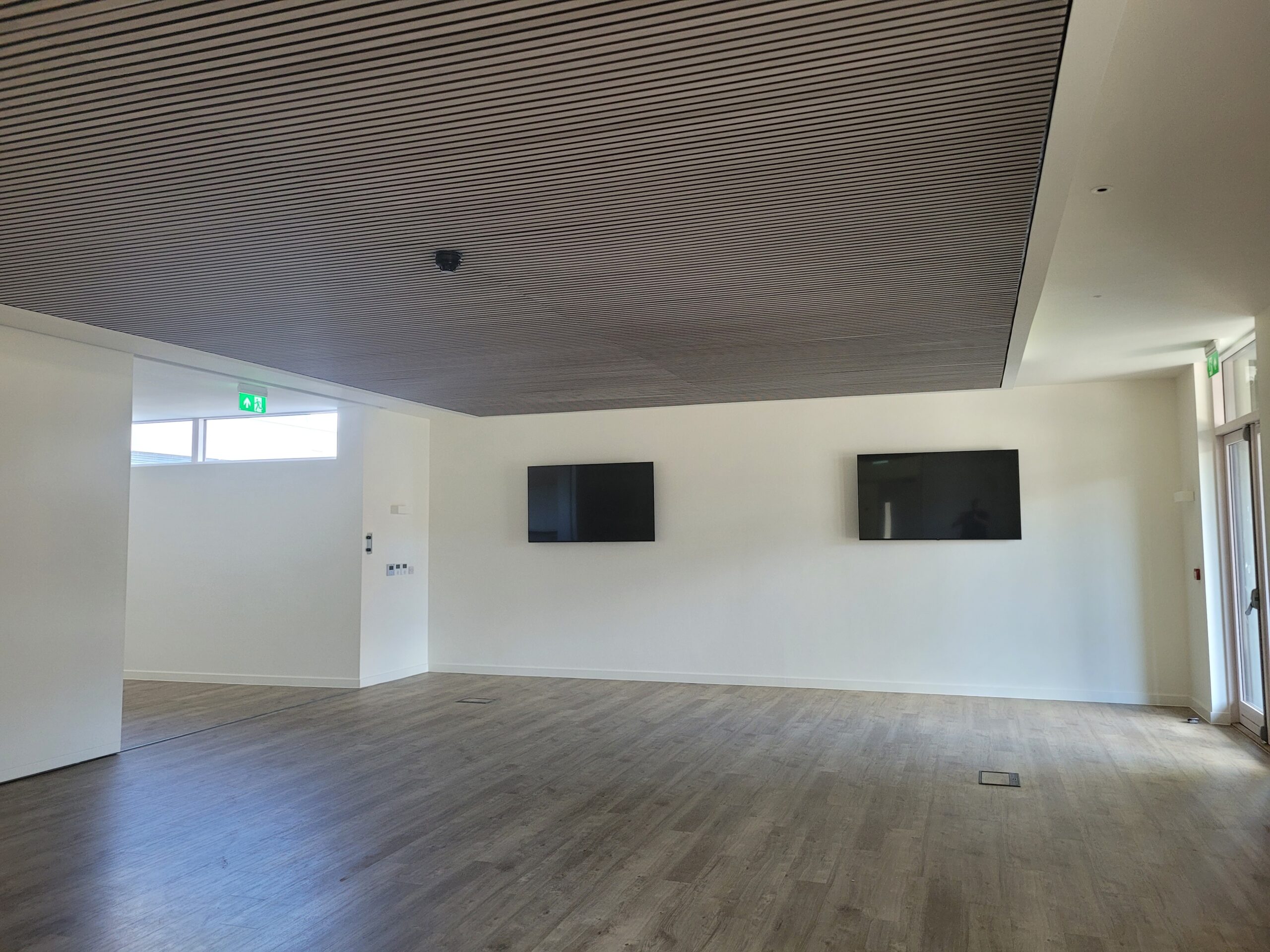 A new acoustic suspended ceiling in an empty room.