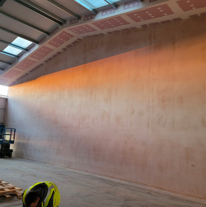 A new drylining and stud wall fitted in a large building.